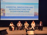 Panel participants seated in front of a backdrop that reads Essential Innovation and Infrastructure for Ocean Knowledge.
